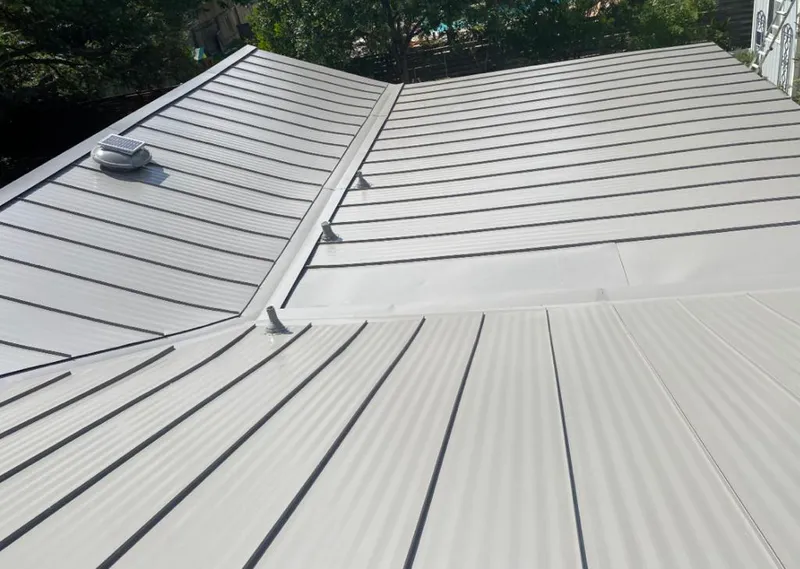 Solar attic fan installed on a metal roof for Roof Ventilation in Temple